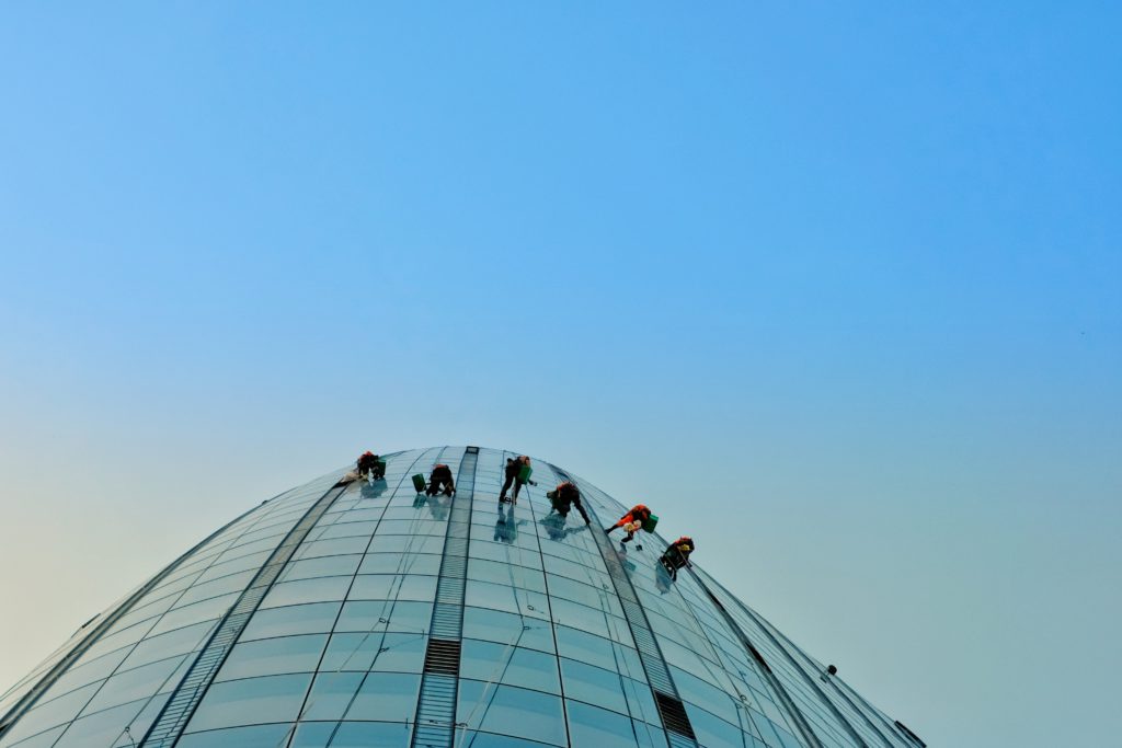 team scaling a building