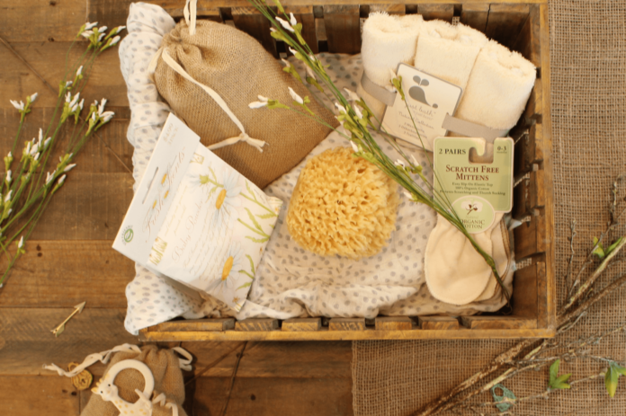 A gift hamper full of self-care items like sponges, wash cloths, soap, salts, and more.