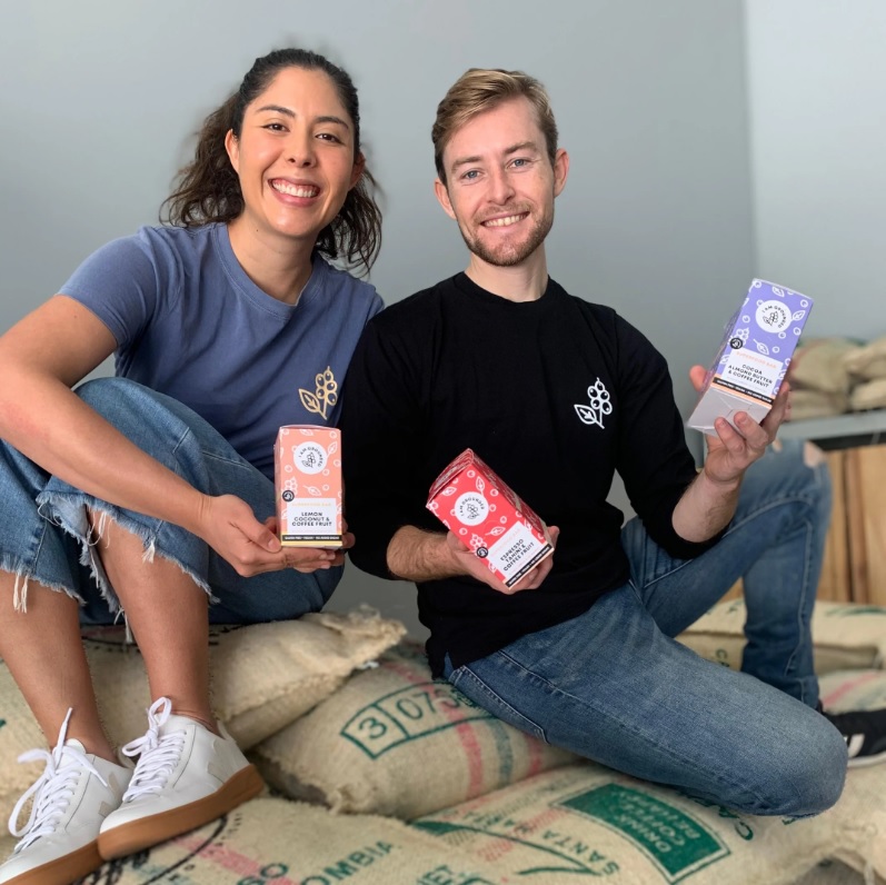 Vanessa and Lachlan, founders of I am Grounded, smiling and posing with their product.